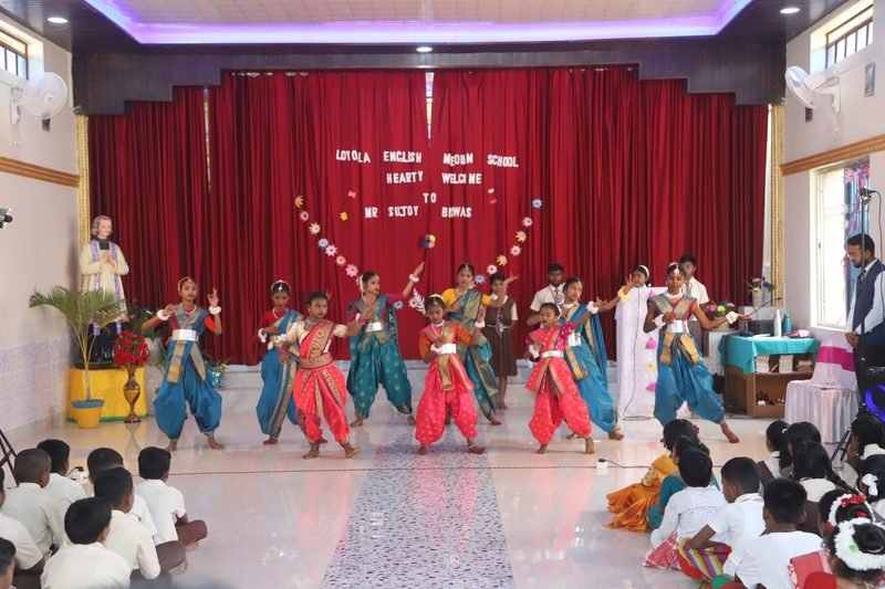 Students performing a traditional dance on the school stage